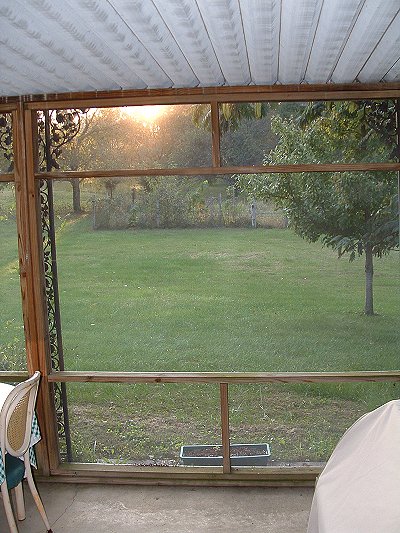 Looking west from inside porch at setting sun